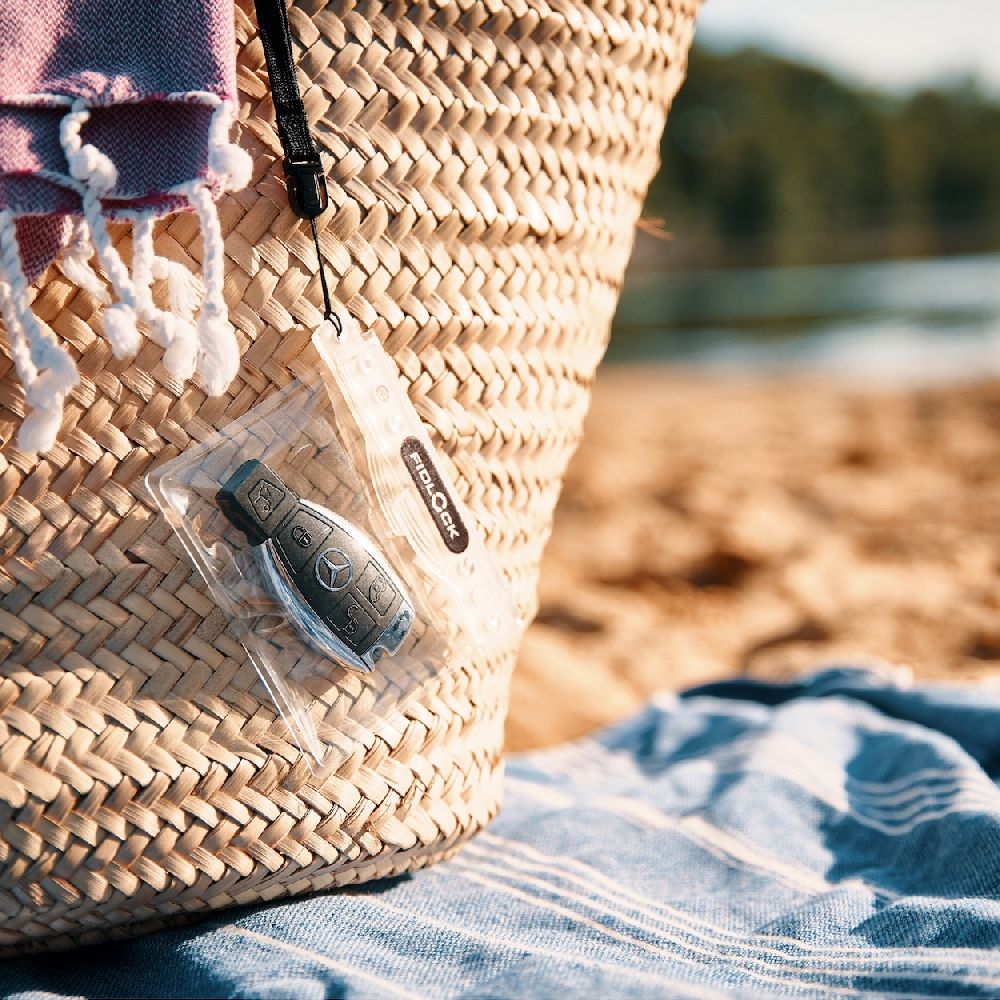 Fidlock Waterproof Dry Case Mini in use with keys on the beach