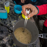MSR Alpine Long Tool Spoon being used to stir food in MSR Trail Lite Pot