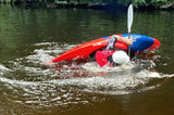Person in a red kayak rolling back up.